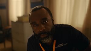 Male looking directly up and toward the camera in a hospital
