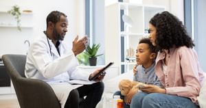 Doctor speaking to mother and her son