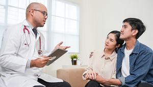 Doctor speaking to parents listening attentively