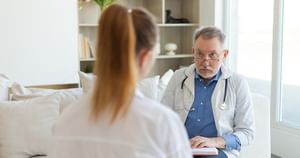 Male health care professional talking to another female health care professional