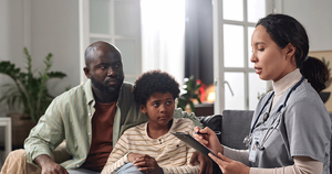 Doctor speaking to father and son