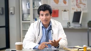 Male doctor speaks facing the camera with expressive hands