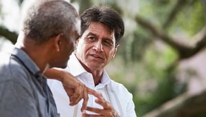 Multi-ethnic men talking to another man outside