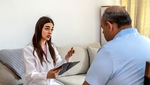 Female doctor speaking to adult patient in the office