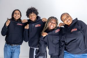 Youth council members wearing project unloaded sweatshirts and smiling at the camera.